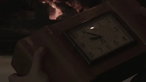 A man looks at an antique clock Stock Footage 74196320