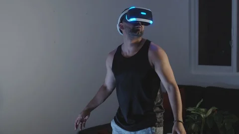 Man Looks Around and Interacts with Virtual Reality Game in Awe and Wonder Stock Footage 108880785