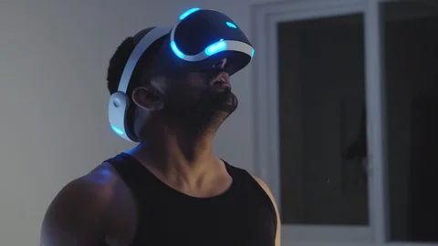 Man Looks Around and Interacts with Virtual Reality Game in Awe and Wonder Stock Footage 108881306