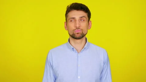 Man looks around at places for text and shrugs, don't knows what to choose Stock Footage 130488564