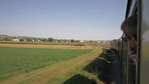 Man looks around from the window of a moving train Video stock 81481584