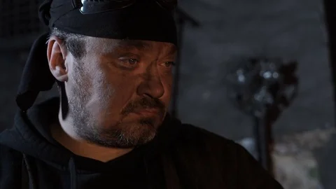 A man looks at a blacksmith fire Stock Footage 69863289