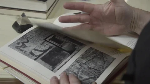 A man looks at a book 스톡 동영상 74195471