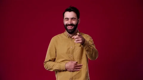A man looks at the camera and laughs at you, jokes Stock Footage 165621335