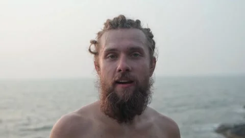 The man looks into the camera and laughs emotionally and rejoices. Video stock 234020965