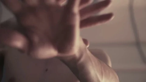 Man looks at the camera and moves his hands Video stock 77380059