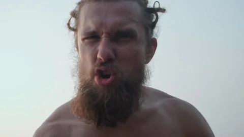 The man looks into the camera with a furious expression. Stock Footage 234020566