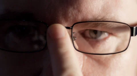 Man looks into camera with glasses Stock Footage 33896107
