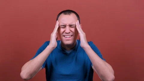 Man Looks at camera, rubs temples with hands, headache. man emotion isolated Video stock 123002441