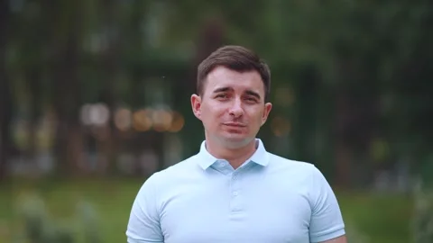 A man looks into the camera, shooting in slow motion Stock Footage 247341020