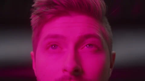 Man Looks Up With Changing Colors On Face Stock-Footage 270310033