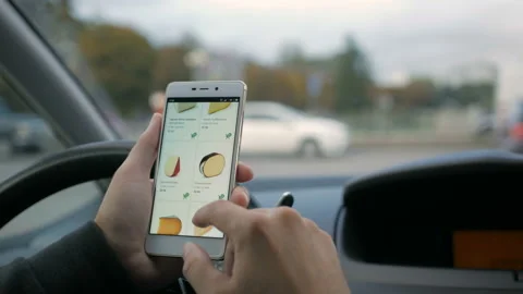 A man looks at the cheese goods in the online grocery store, sitting in the c Stock-Footage 95844853