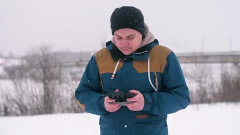 A man looks into the control quadcopter. Control drones in winter Stock Footage 147182091