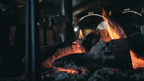 Man looks at crest of flame on burning wood in fireplace Stock Footage 102804541