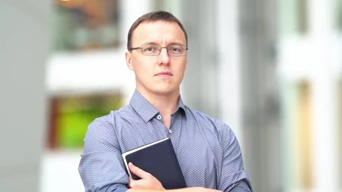 The man looks directly into the camera.A slow-motion medium plan of a young Stock Footage 220830620