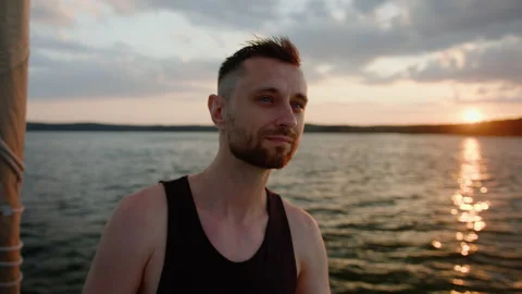 A man looks into the distance of the lake plotting the route of a boat trip Stock Footage 235997492