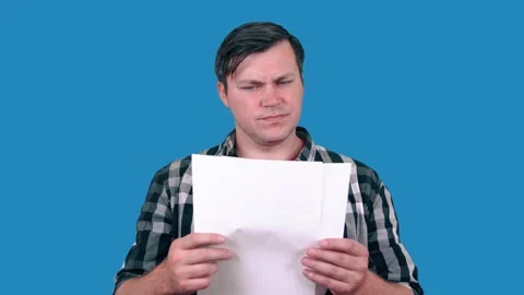 The man looks at the documents and tears them, tears the paper. Stock Footage 148375669