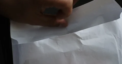 Man looks into the envelope which is pack of 100 dollar bills Stock Footage 96031979