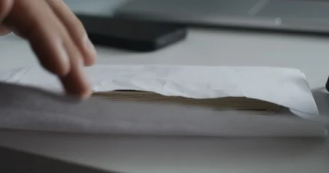 Man looks into the envelope which is pack of 100 dollar bills Vídeo Stock 96033768