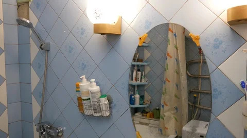 A man looks at himself in the mirror Stock-Footage 127573576