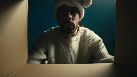 Man looks inside a Christmas box Stock Footage 220724688
