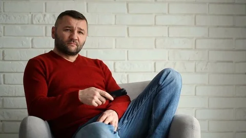 Man looks irritated while changing channels on tv Stock Footage 73497928