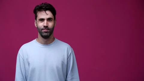 Man looks to the left and points his finger and smiles Stock Footage 162843095