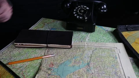 A man looks at a map and writes a route in a notebook Stock Footage 102229612