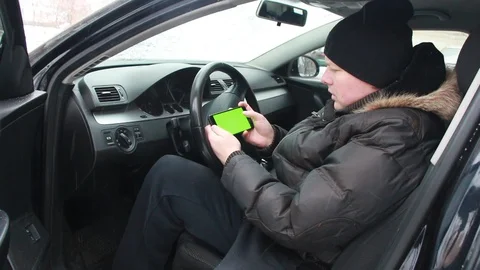 Man looks at a map on his smartphone. the guy is playing the game on the phone. Video stock 101807903