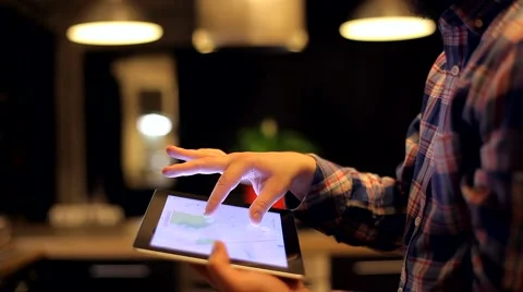 Man Looks at the Map on the Tablet a Beautiful and Cozy Background Stock Footage 48675632