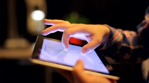 Man Looks at the Map on the Tablet a Beautiful and Cozy Background Video stock 48675638