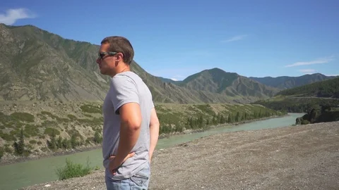 A man looks at a mountain valley Stock Footage 117772201