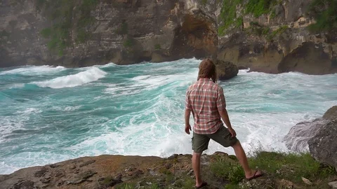 Man looks at ocean waves Stock Footage 85503856