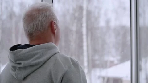 The man looks out of the open window and closes it Stock Footage 167050864