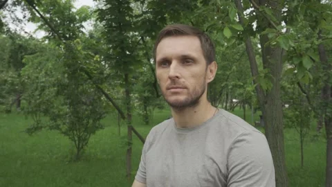 The man looks out for something, and then hides behind the frame Stock Footage 155546484