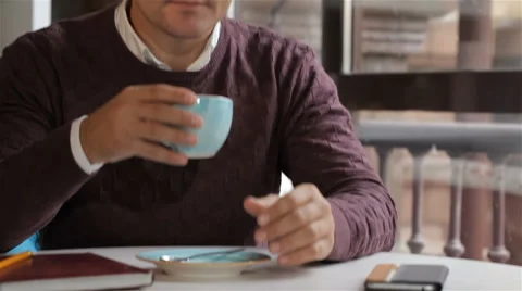 Man looks out the window at the cafe Stock Footage 68526513