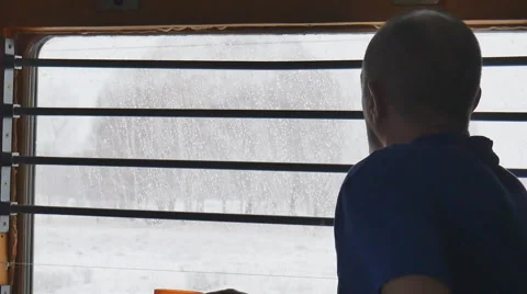 A man looks out the window in the train Stock Footage 61772477