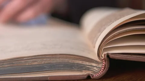 A man looks over some old historical books in a library in Belfast. Stock Footage 147872077