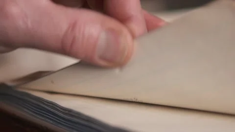 A man looks over some old historical books in a library in Belfast. Stock Footage 147872093