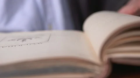 A man looks over some old historical books in a library in Belfast. Stock Footage 147872163