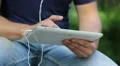 Man looks the photos in his tablet computer. Man holds in hands white tablet pc HD Footage