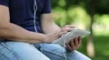 Man looks the photos on tablet computer. Man holds in hands white tablet pc HD Footage