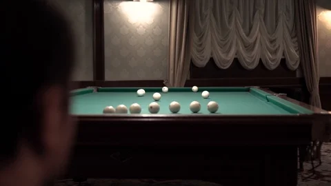 A man looks at a pool table Stock Footage 98450856