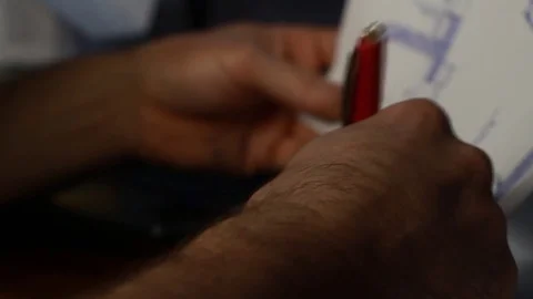 A man looks at a project and makes notes on the computer Stock Footage 85246003