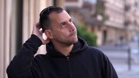 Man looks puzzled after reading strange message Stock Footage 308636445