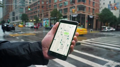 Man Looks at Ride Sharing Traffic Patterns on Smartphone   Video stock 81126437