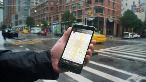 Man Looks at Ride Sharing Traffic Patterns on Smartphone   Video stock 81126659