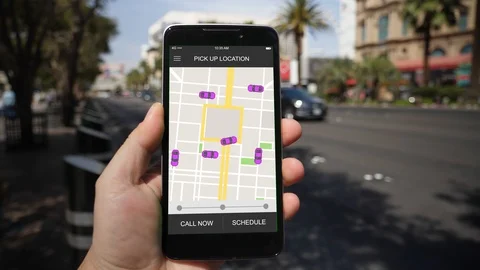Man Looks at Ride Sharing Traffic Patterns on Smartphone Video stock 88433151