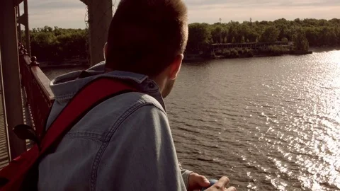 Man looks at the river at dawn Vídeo Stock 79735157