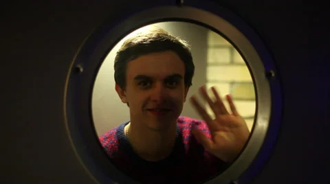 Man Looks in Round Window 스톡 동영상 60822317